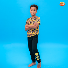 Load image into Gallery viewer, Child wearing a yellow and black patterned shirt with matching pants on a blue background