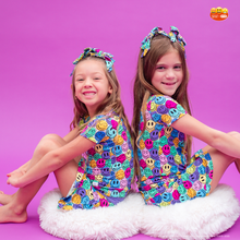 Load image into Gallery viewer, Two children wearing colorful emoji-patterned outfits on a purple background