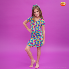 Load image into Gallery viewer, Young girl wearing a colorful emoji dress on a purple background