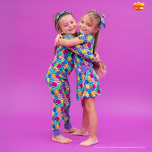 Load image into Gallery viewer, Two children wearing colorful pajamas with a smiley face pattern on a purple background.