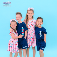 Load image into Gallery viewer, Four children wearing matching &#39;Smurfs&#39; themed pajamas on a blue background