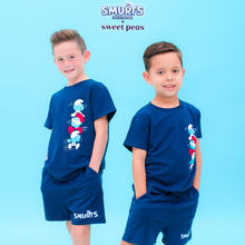 Load image into Gallery viewer, Two children wearing matching blue &#39;Smurfs&#39; pajama sets on a light blue background.