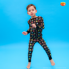 Load image into Gallery viewer, Child wearing a colorful geometric patterned outfit on a blue background
