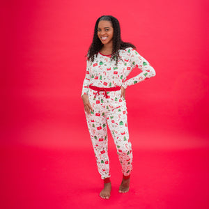 Woman wearing a festive pajama set against a red background