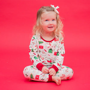 Child wearing a festive pajama set on a red background