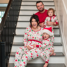 Load image into Gallery viewer, Family of four wearing matching Christmas pajamas sitting on a staircase.