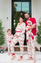 Load image into Gallery viewer, Family of four wearing matching pajamas in front of a house entrance.