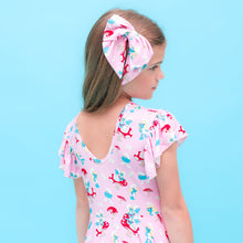 Load image into Gallery viewer, Young girl wearing a Smurfs dress and headband against a blue background